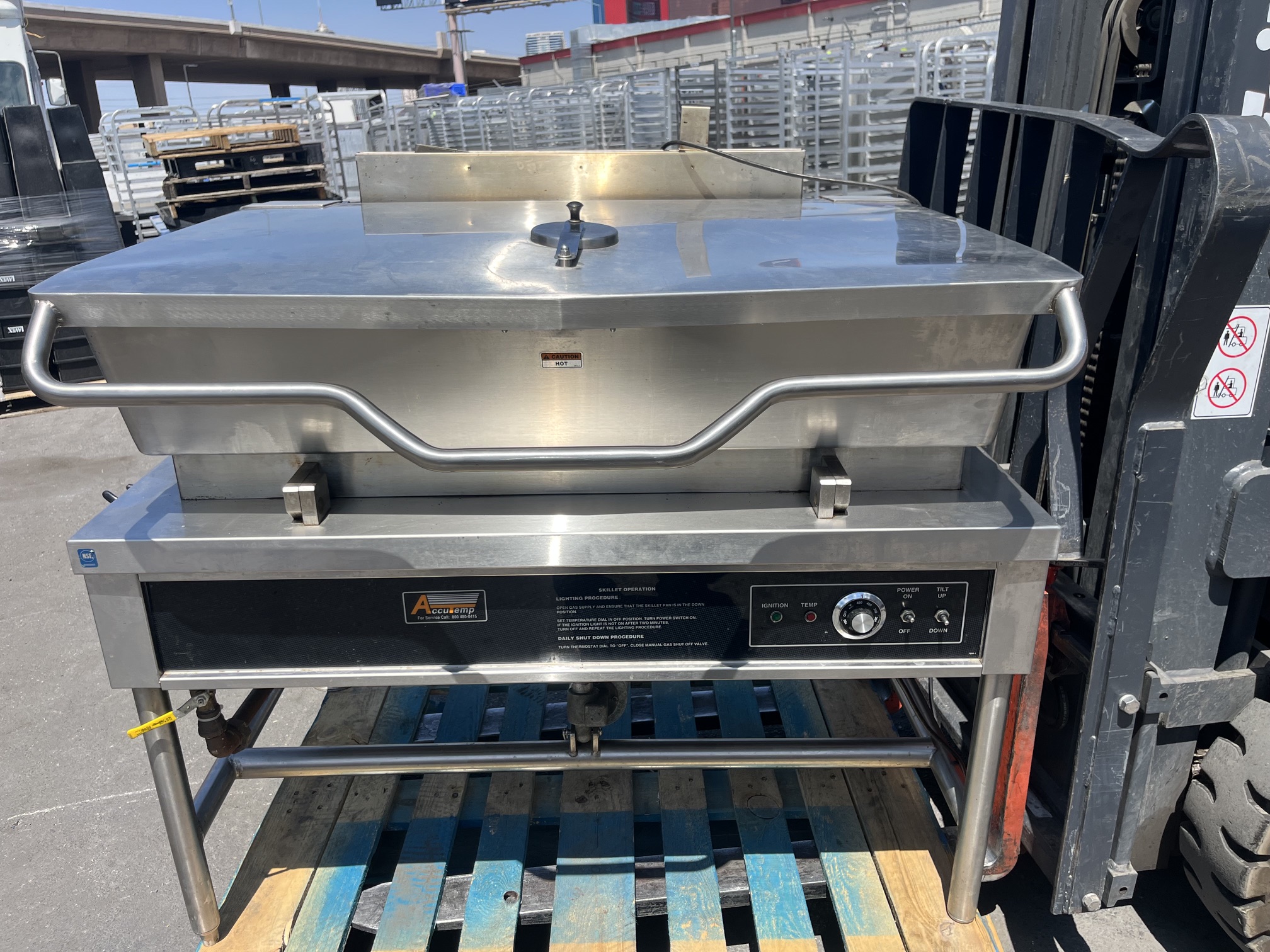 AccuTemp ACGLTS-40 40-gallon gas tilt skillet with lid closed, showing front control panel with ignition, thermostat, power and tilt switches on open stainless steel stand