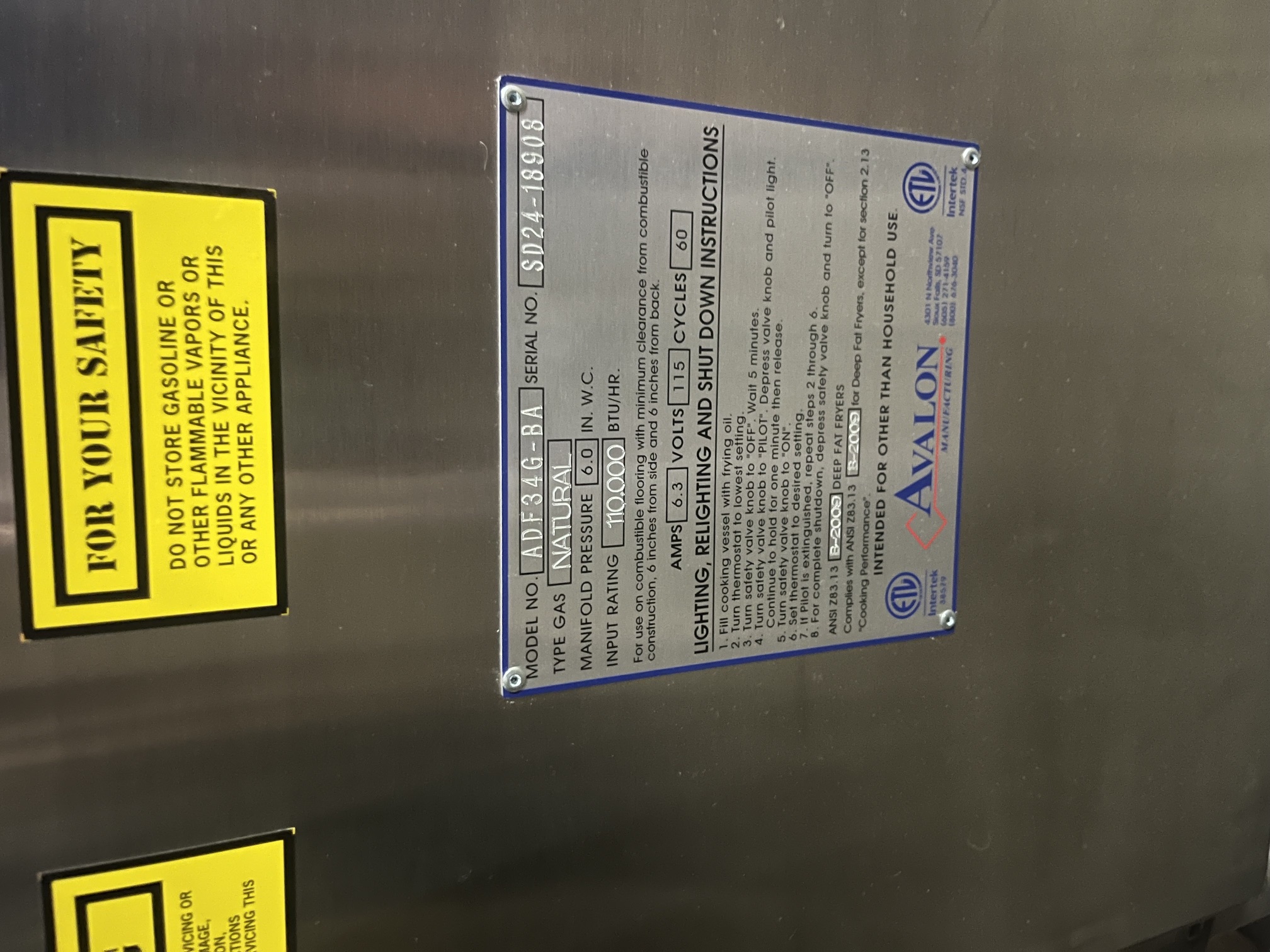 Data plate on Avalon ADF34G-BA fryer showing model, serial SD24-18908, natural gas, 110,000 BTU/hr, 115V, 6.3 amps
