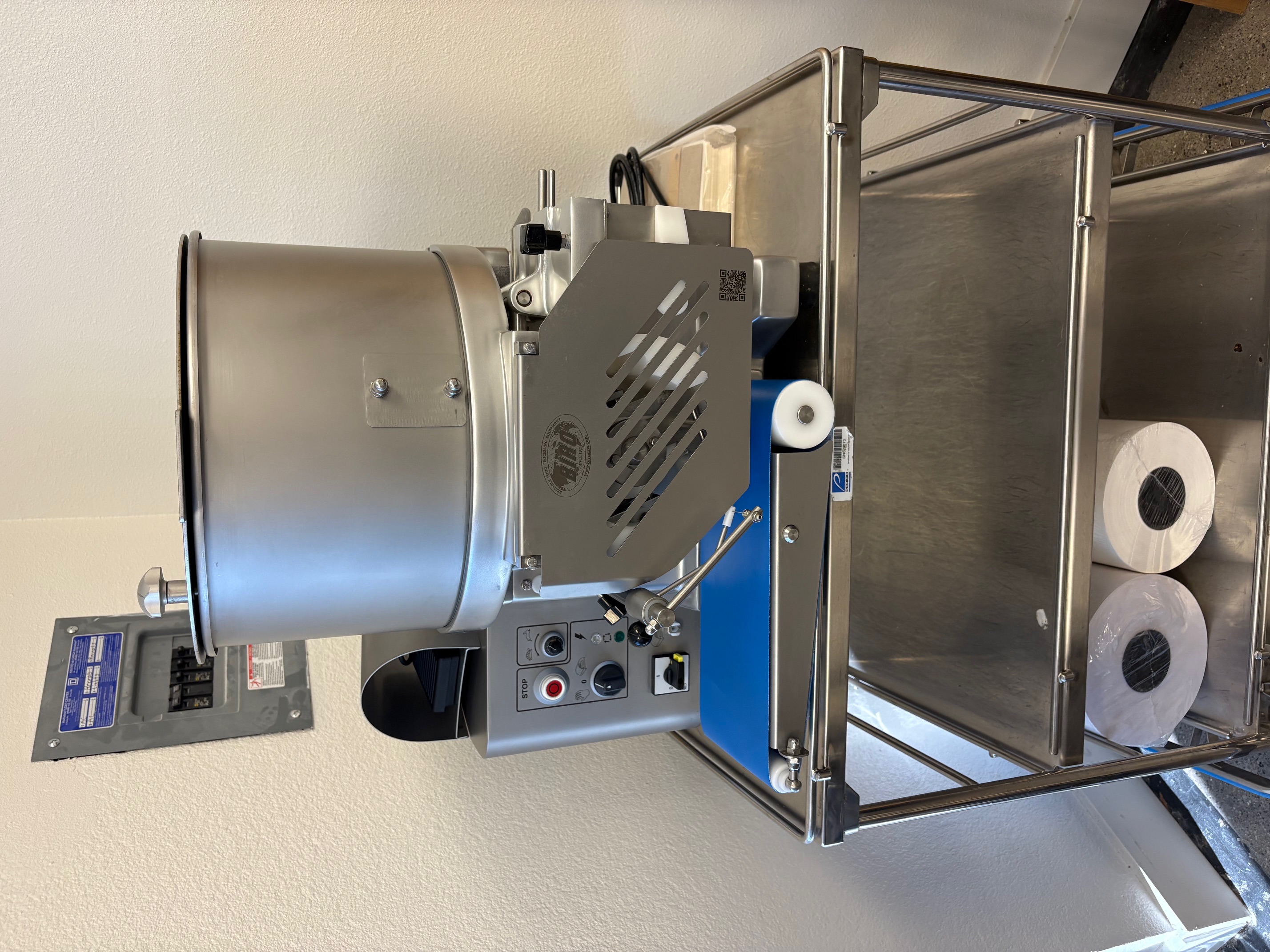 Front-right view of Biro F2000PLUSB patty former showing the full unit with hopper, controls, and power cord on stainless steel cart