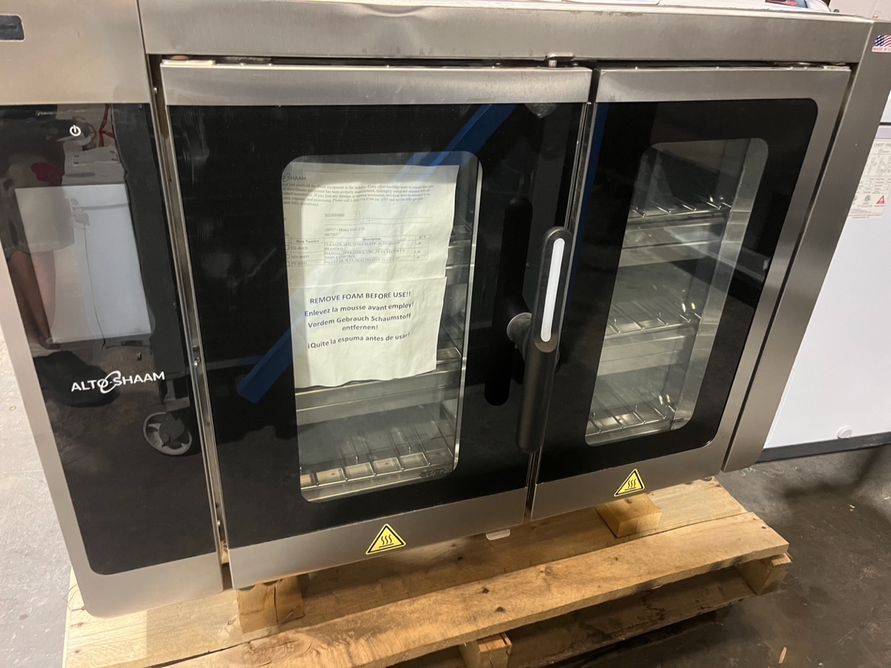 Alto-Shaam VMC-F3E on pallet showing front view with factory packing slip and 'Remove Foam Before Use' notice still attached