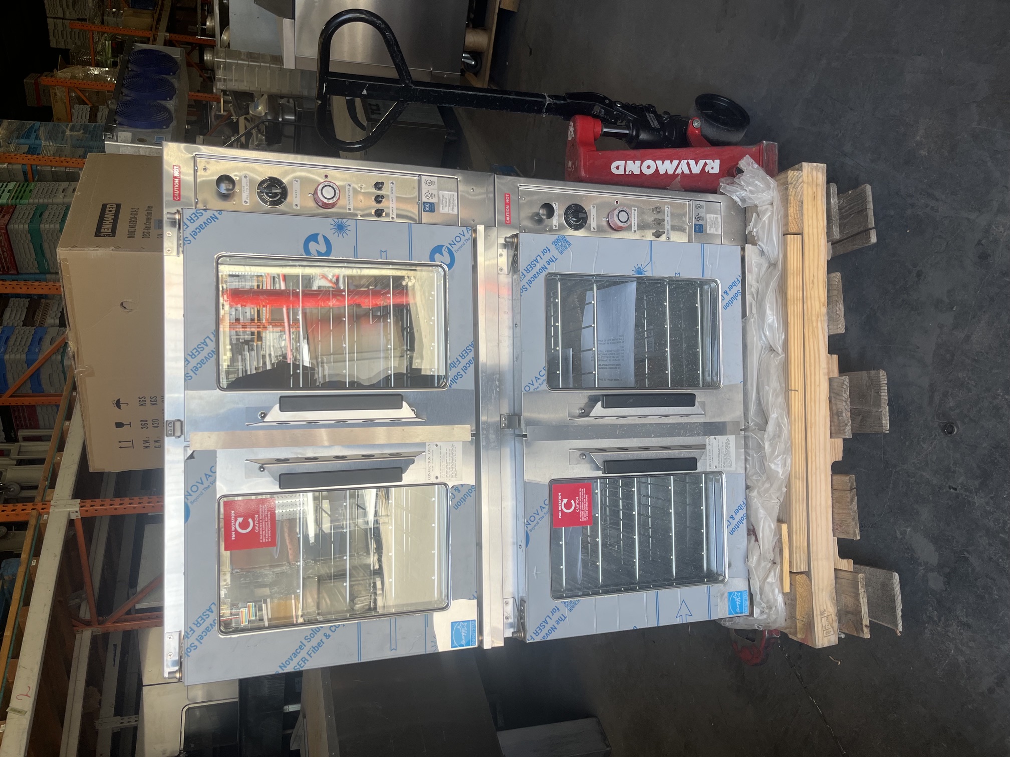 Front view of brand new Lang ECOF-AT-440M double stack electric convection oven on pallet with protective film still applied