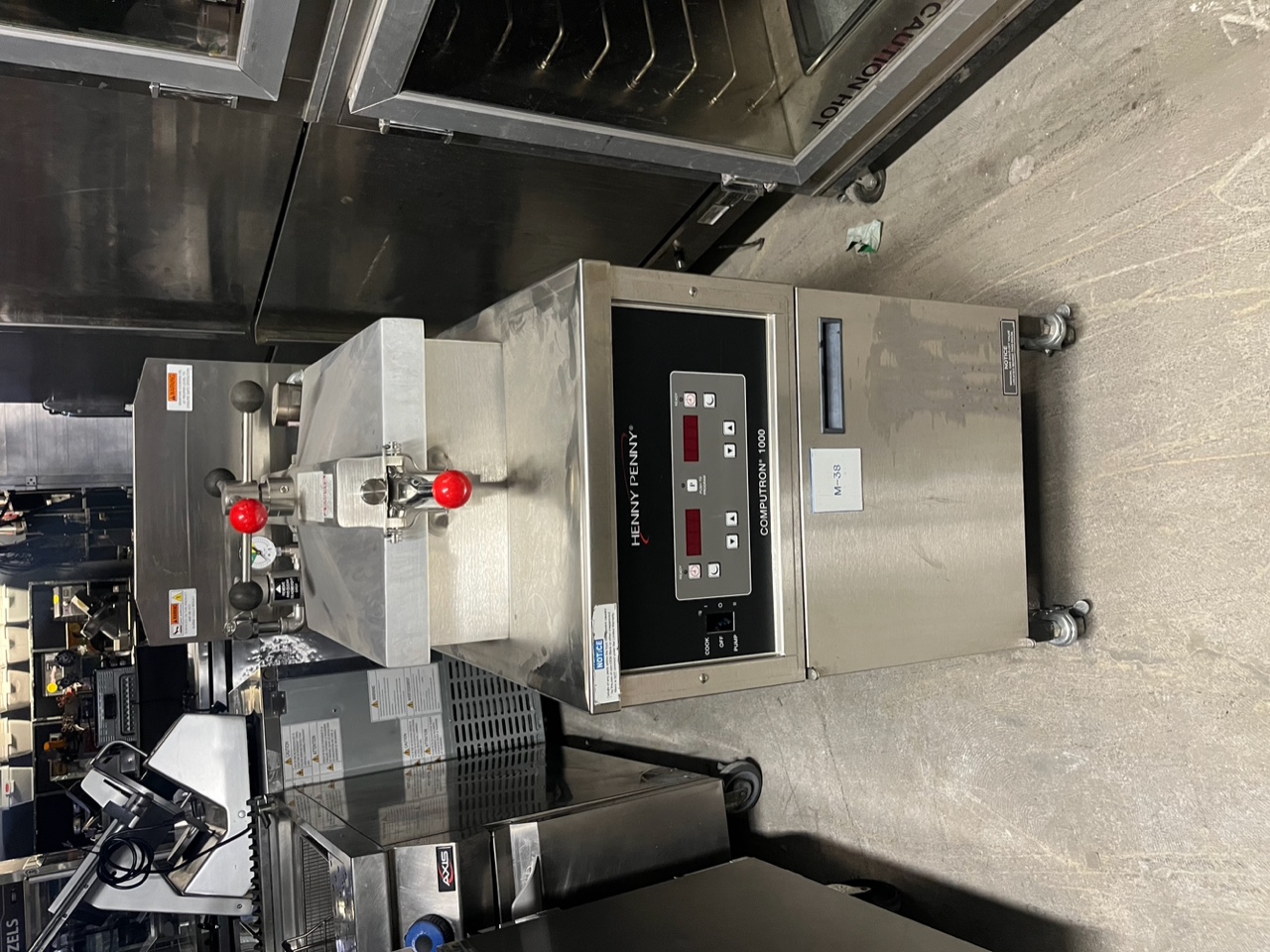 Front view of Henny Penny PFG-600 gas pressure fryer with Computron 1000 control panel and stainless steel construction on casters
