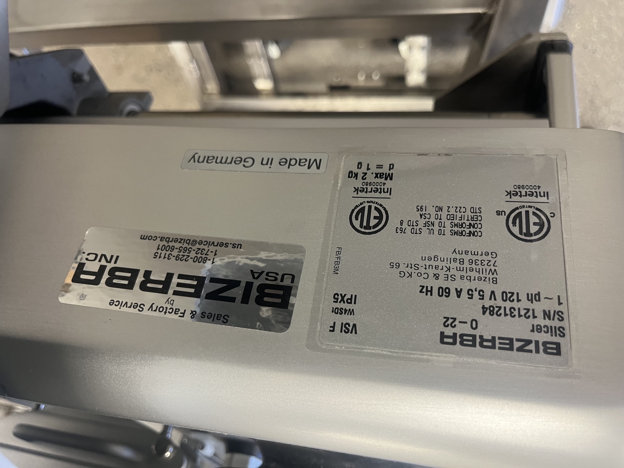 Bizerba data plate showing model VSI F, serial number 12131284, 120V 5.5A 60Hz, Made in Germany, with ETL and Bizerba USA service labels
