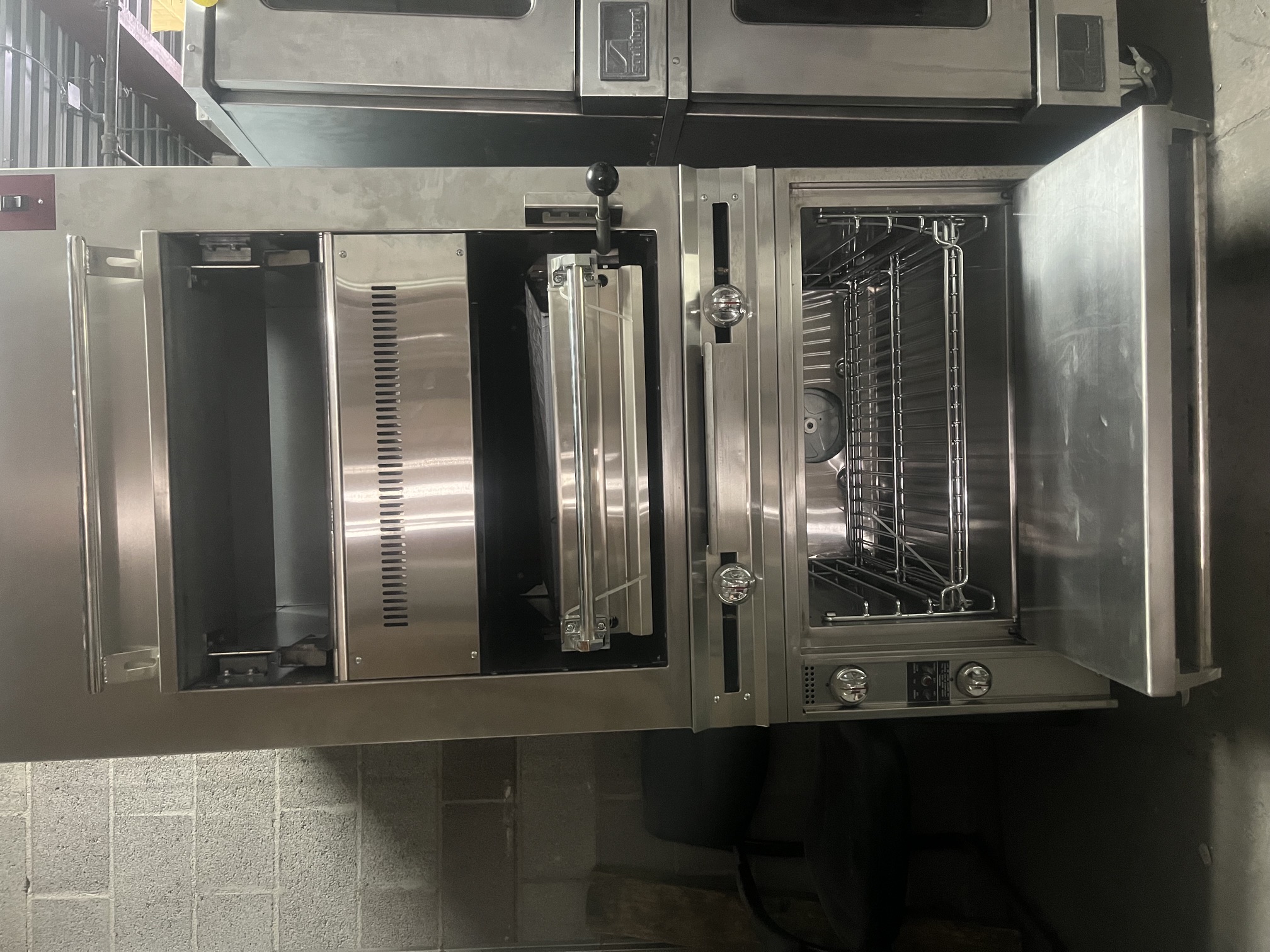 Front view of Jade Range JSHBI-36H-36C with lower oven door open showing interior rack and clean stainless steel oven cavity
