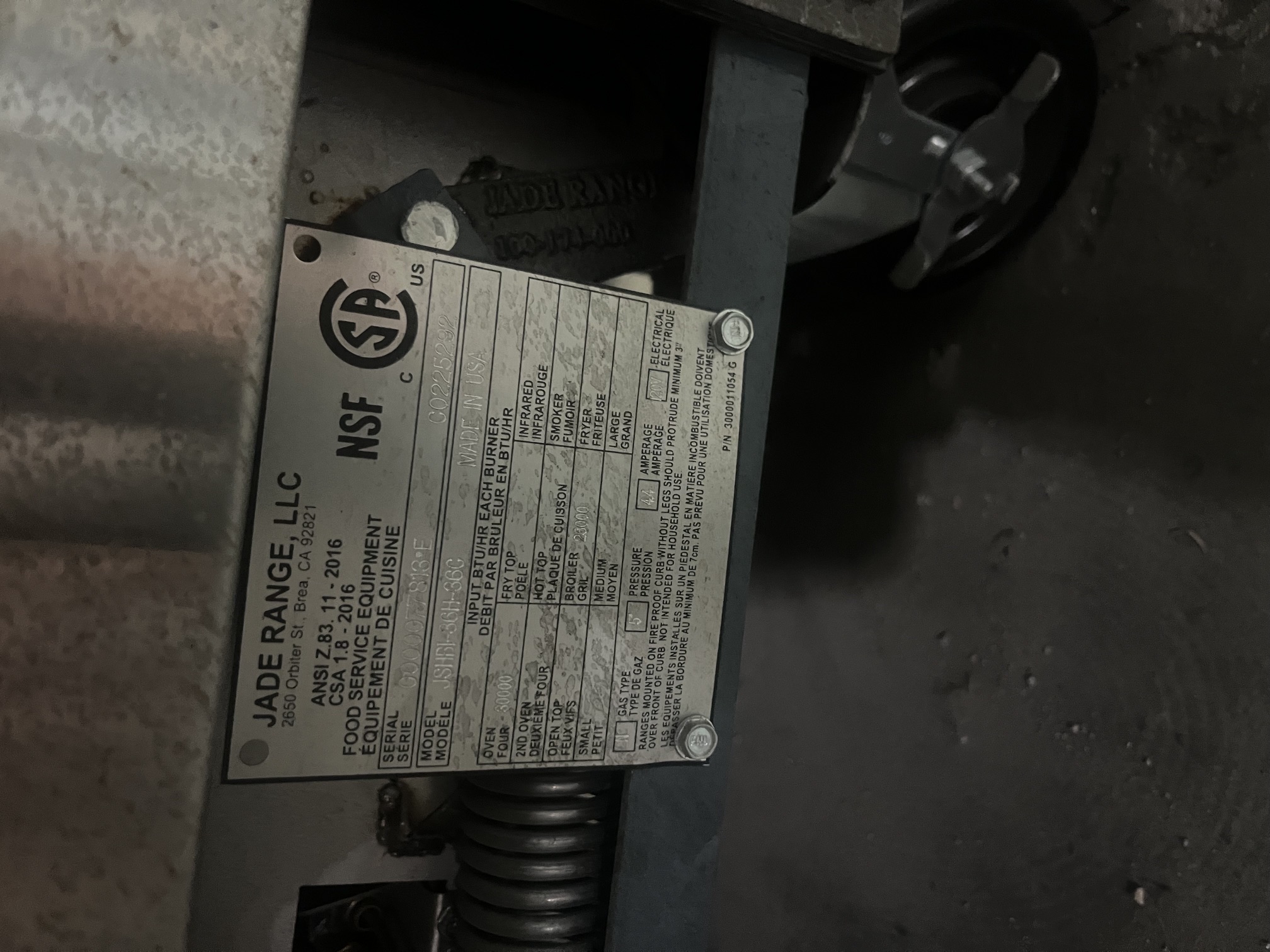 Close-up of Jade Range data plate showing model JSHBI-36H-36C, serial number, BTU ratings, gas type, and NSF/CSA certifications