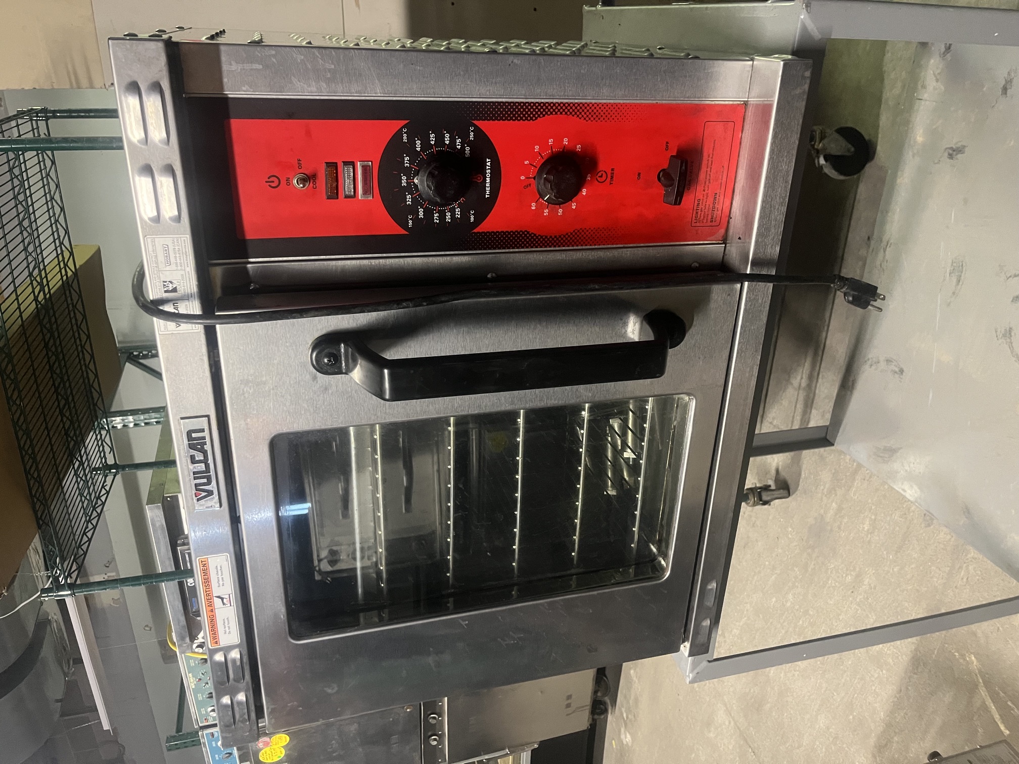 Vulcan GCO2D half-size natural gas convection oven with red control panel showing thermostat and timer dials, glass door closed, on a metal stand