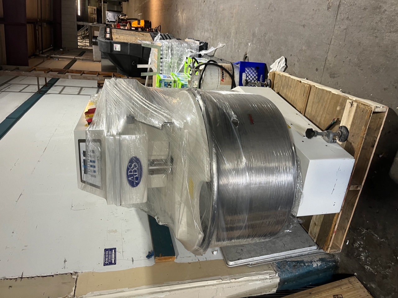 Front view of Sinmag SM-200T spiral mixer with ABS Baking Systems logo, wrapped in plastic on wooden pallet
