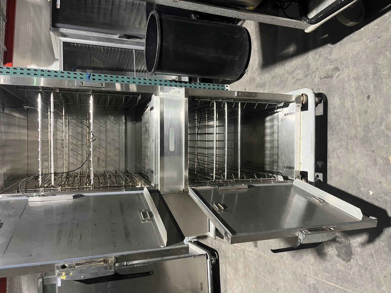 Alto-Shaam 1200-TH/III with both upper and lower compartment doors open revealing rack guides and stainless steel interior on casters