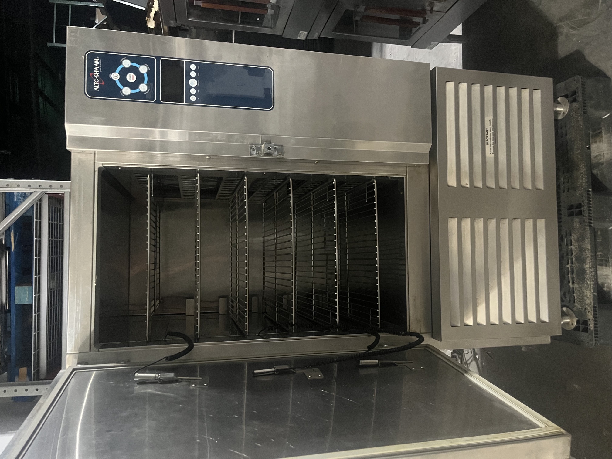 Alto-Shaam QC40B blast chiller with door open showing six wire shelves and stainless steel interior