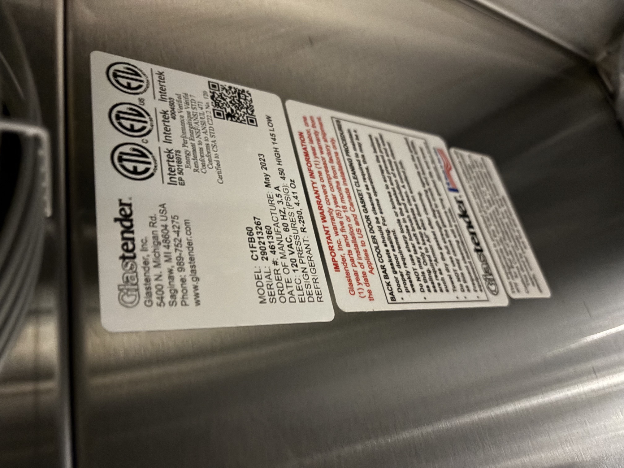 Glastender C1FB60 data plate showing model number, serial number, electrical specs, and May 2023 manufacture date on stainless steel interior