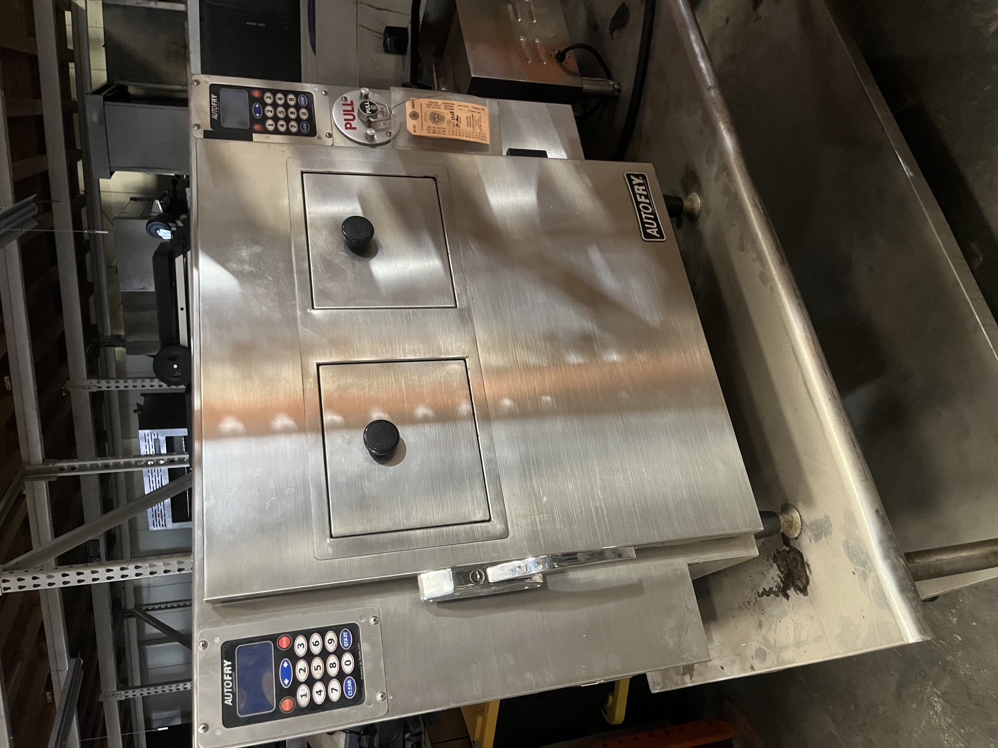 AutoFry MTI-40 ventless automated fryer, front view showing stainless steel enclosure, dual digital keypads, two access doors, and fire suppression pull handle